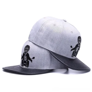 Multiple stacked gothic snapback caps displaying side view of skull motorcycle embroidery and adjustable snapback closure