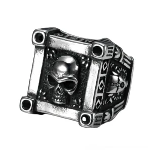 Side-top oblique view of embossed gothic skull biker ring featuring geometric frame and black gem inlays in vintage silver tone