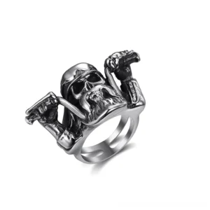 Gothic skull biker rider ring in vintage silver stainless steel, shown from oblique angle highlighting intricate skull design and band width