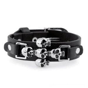 Adjustable leather gothic punk bracelet flat lay overhead showing multiple skull details and toggle clasp
