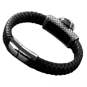 Black leather gothic skull bracelet side close-up showing braided leather strap, polished metal hardware, and detailed skull decoration with fedora