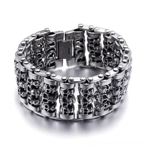 Silver-tone gothic skull chain bracelet front view with interlocking skull heads on white background