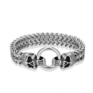 Stainless steel skull link bracelet with dual skull clasp and wheat chain, flat overhead view on white background