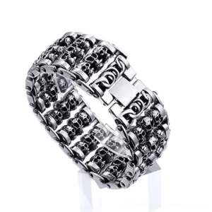 Multi-skull gothic bracelet side angle view on display stand showing detailed skull link construction