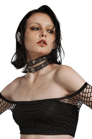 Gothic double strap skull choker worn by model in fishnet crop top, front three-quarter view showcasing bold metal rivets and skull pendant detail