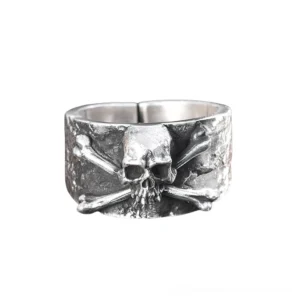 Solid sterling silver gothic ring with skull and crossbones design, front flat view showing hammered texture and open adjustable band