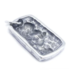 Back view of matte finish gothic skull pendant showing rough textured surface and organic aged patina on stainless steel
