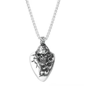 Gothic skull guitar pick pendant necklace in silver stainless steel, displayed on white studio background showing front full view of carved skull and intricate embossed flame details