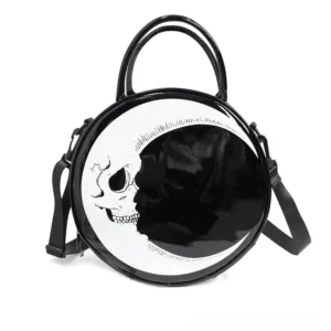 Crescent moon skull round gothic handbag front view, glossy black synthetic leather with skull crescent print, dual handles and crossbody strap