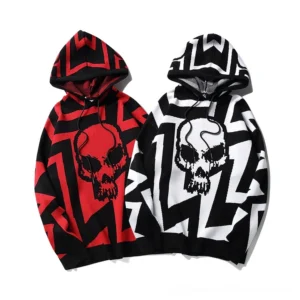 Oversized gothic skull knit hoodies in red and white - flat lay studio product view showing both color options with geometric knit pattern