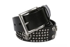 Black gothic skull studded leather belt with silver metal studs and skull motifs on white background overhead view