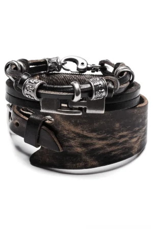Vintage leather punk bracelet set with skull beads - overhead flat lay view showing three-piece gothic bracelet collection with distressed brown cowhide and antique bronze metal hardware on white background