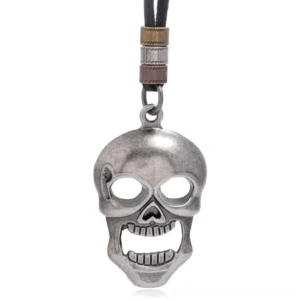 Antique silver skull pendant on genuine leather cord, front close-up view showing carved skull details and metal beads