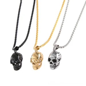Three-color stainless steel skull pendant necklaces in black, gold, and silver - gothic memorial jewelry flat lay