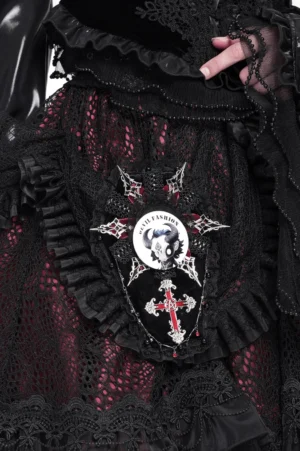 Gothic horned skull pin badge styled on black leather jacket with gothic fashion ensemble and lace details