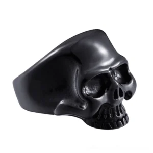 Black matte stainless steel skull ring with high-polished finish, side three-quarter view on white background