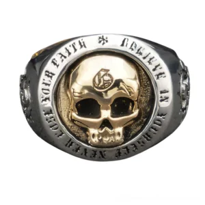 Front facing view of 925 sterling silver skull ring featuring gold-toned skull centerpiece with engraved text border and vintage silver finish