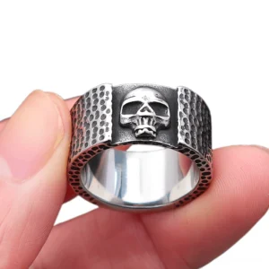 Hammered gothic skull ring worn on hand showing detailed skull motif and dotted texture surface