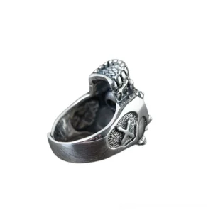 Gothic skull ring inner side view displaying rivet decorations, cross embossed pattern on the band, hollow skeleton structure, and mixed oxidized and polished silver finish