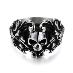 Ornate vintage gothic skull ring with floral scroll filigree, front oblique view showing aged stainless steel patina and intricate carved details