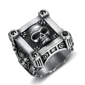 Gothic stainless steel skull ring with black diamond accents and vintage silver finish, top-down view showing intricate carved skull details and geometric frame design