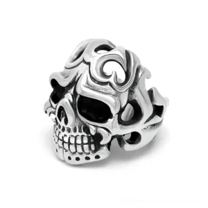 Unisex stainless steel gothic skull ring with intricate hollow carved floral design, front oblique view on white background