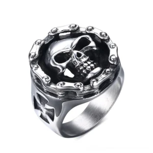 Polished stainless steel gothic skull signet ring with riveted frame detail and geometric cross cutouts on band - three-quarter top view