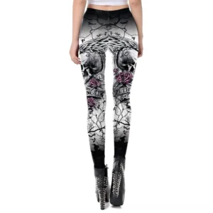 Women's gothic skull leggings three-quarter back view featuring tattoo-inspired rose and skull pattern, worn with studded platform boots