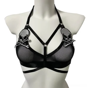 Black gothic skull transparent harness bra with crisscross front straps and embroidered skull motifs, front view on mannequin