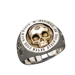 Sterling silver gothic skull signet ring with dual-tone metal design and sun emboss detailing on band, photographed in 3/4 side angle view