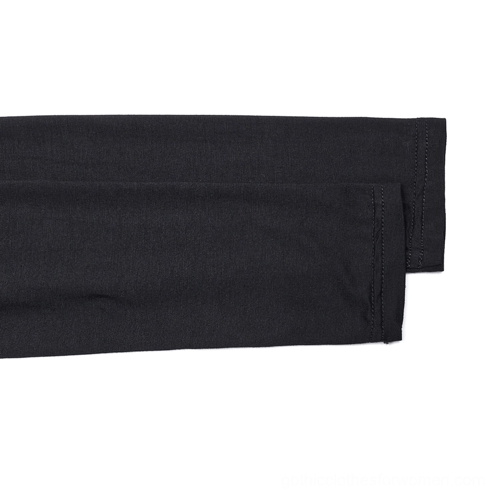Close-up flat lay of sleeve cuff and long sleeve on black gothic skeleton print top showing reinforced stitching and stretch knit fabric