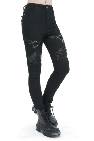 Black gothic slim-fit pants with thigh O-rings and lace-up knee details, worn by female model with platform boots, front oblique view