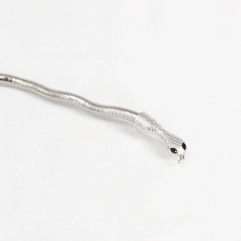 Gothic silver snake jewelry close-up detail showing intricate snake head with defined eyes and textured scales