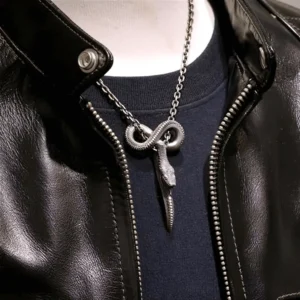 Vintage carved gothic snake pendant necklace worn on male mannequin with aged silver finish and biker leather aesthetic
