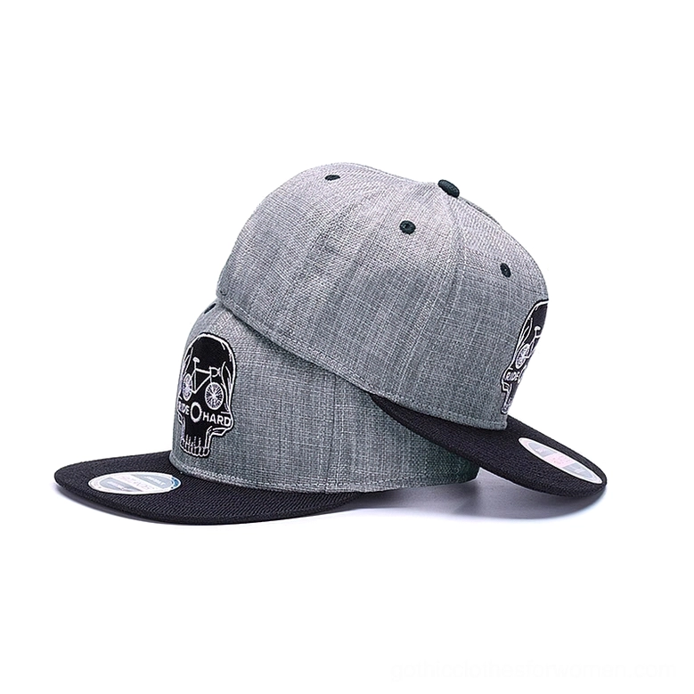 Rear view of two matching gothic snapback caps displaying embroidered skull design and back adjustment