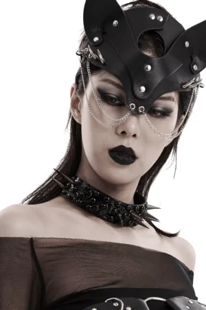 Black spiked gothic choker with 3D rivets worn by female model with gothic makeup and face mask accessory, front close-up studio view