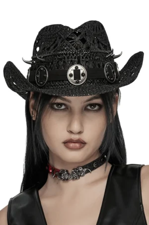 Black gothic spike cowboy hat front view on goth model - straw weave with metal spike trim and dark aesthetic