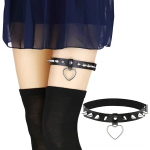 Black spiked heart leg garter belt worn on model's thigh with silver metallic studs and hollow heart pendant, styled with gothic fashion