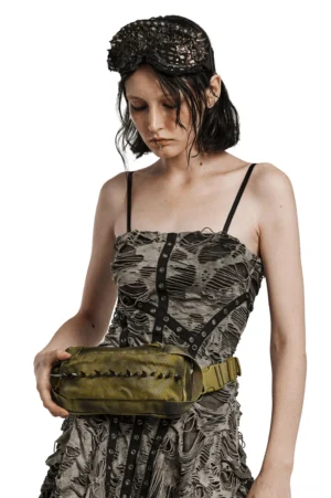 Olive spiked gothic crossbody bag front view on alternative female model, metal studs detail, faded nylon fabric with punk aesthetic