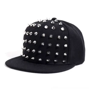 Black spiked snapback cap with silver metal cone spikes on crown, front three-quarter studio view