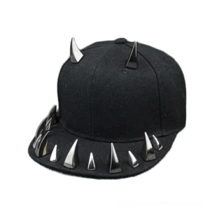 Black spiked snapback baseball cap with silver cone studs and dual horn crown spikes, left three-quarter perspective view