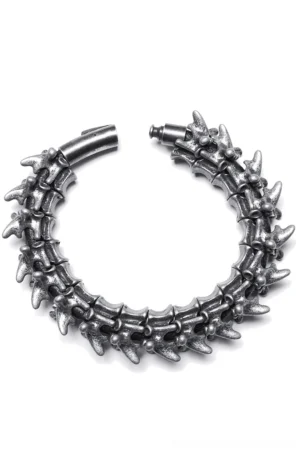 Skeletal spine metal bracelet flat lay top-down view showcasing linked vertebrae segments and oxidized silver finish