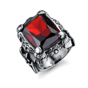 Gothic square blood red zircon ring with stainless steel band, oblique front view showing claw-set gemstone and embossed vintage texture on white background