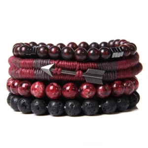 Red gothic layered stone bracelet set with terracotta and reddish-brown stone beads, speckled red accents, black lava beads, and wine-red woven band with metal arrow ornament