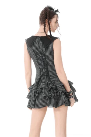 Black and white striped gothic dress back view showing lace-up corset back design with crisscross lacing on model