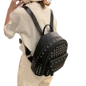 Women wearing black rivet backpack side view with adjustable leather shoulder strap and alternative fashion styling