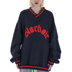 Navy blue gothic letter patch v-neck baseball sweatshirt front view on female model with red striped ribbed trims