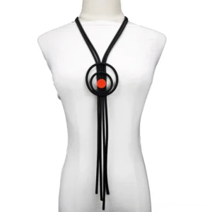 Black gothic long tassel necklace with red accent displayed on white mannequin torso, front view showing full pendant length and rope chain design