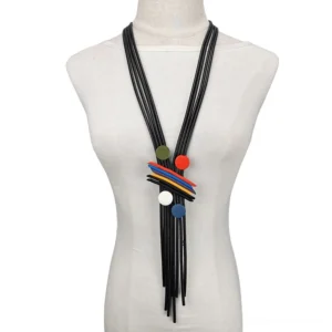 Black multi-strand tassel gothic necklace displayed on dress form mannequin, featuring geometric colorful pendant discs and dramatic fringe detail