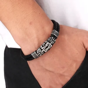 Men's dark totem leather bracelet worn on wrist, casual styling demonstration with everyday clothing background